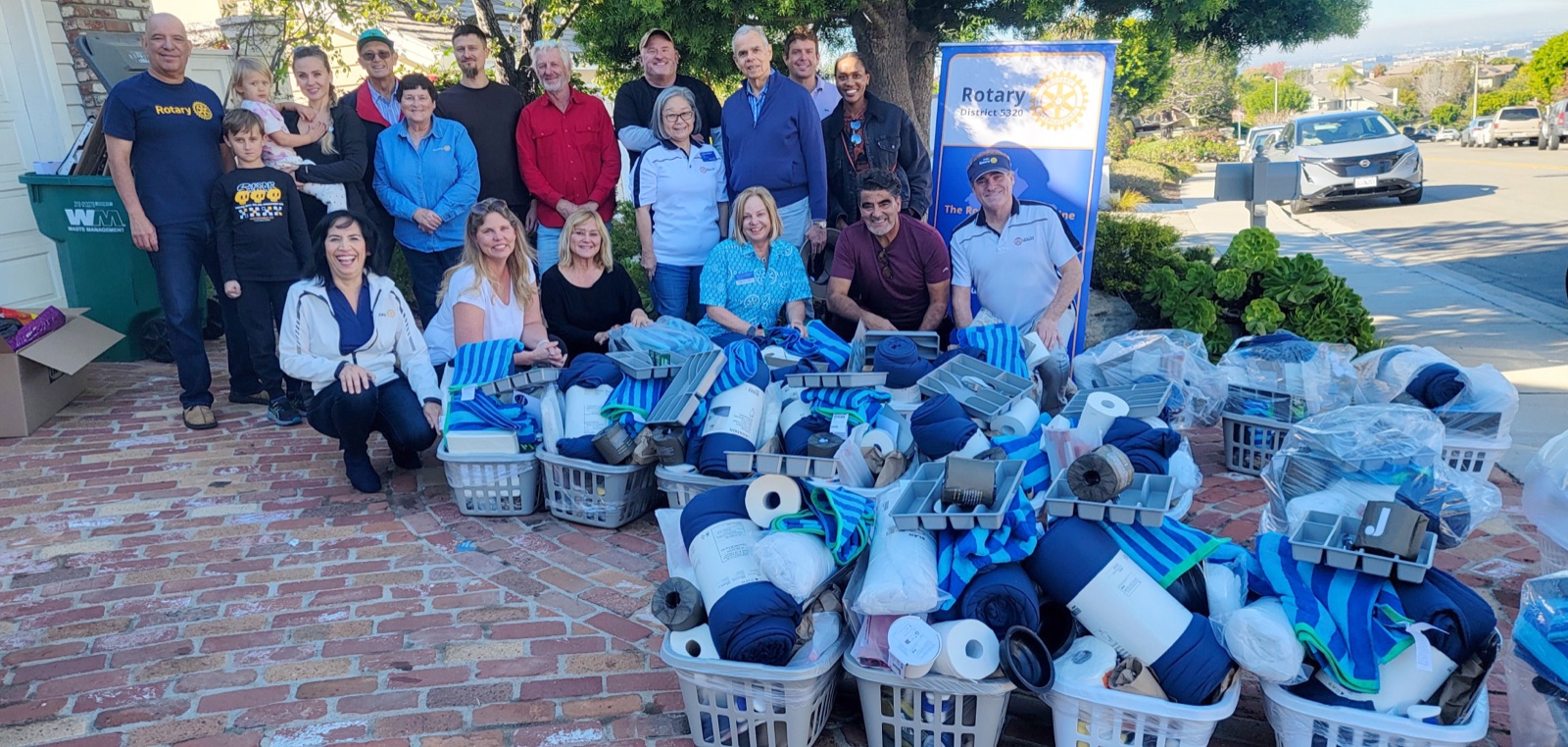 Irvine Rotary members with home baskets for Mercy House veterans